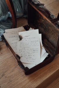 Pile of burnt paper with texts in retro box indoors